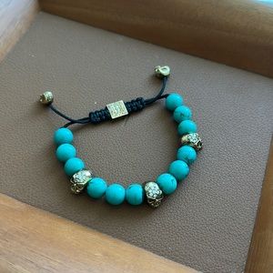 Jai Dam turquoise stone with 18k gold skulls adjustable bracelet